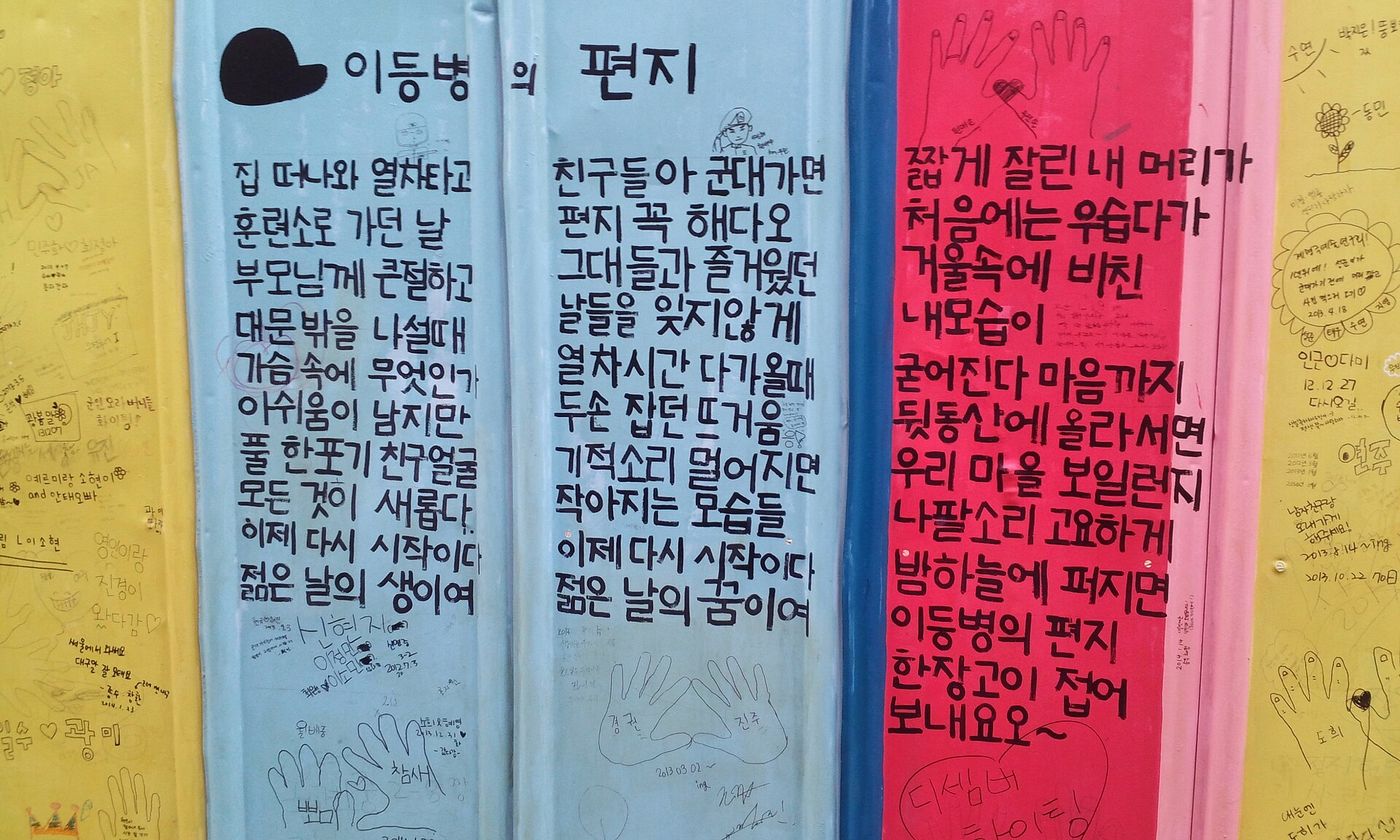 김광석 다시그리기 길 — 방천시장 옆 담벼락에 김광석의 노랫말이 색색으로 그려져 있다